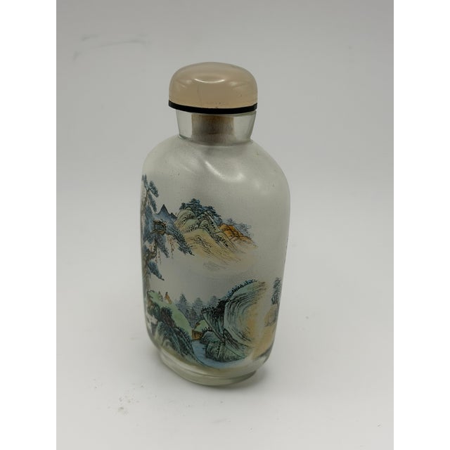 Inside-painted bottles, where artists use specially curved brushes to paint intricate scenes on the interior surface of...