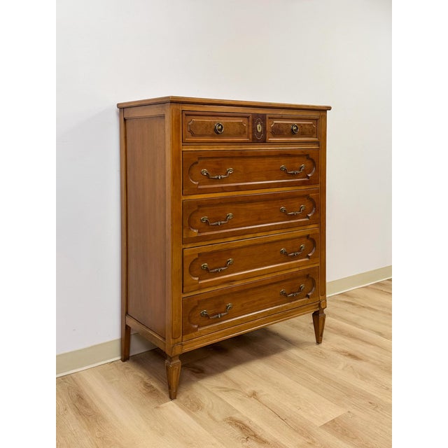This vintage tallboy dresser by Thomasville brings a refined, transitional sensibility to bedroom storage, featuring rich...