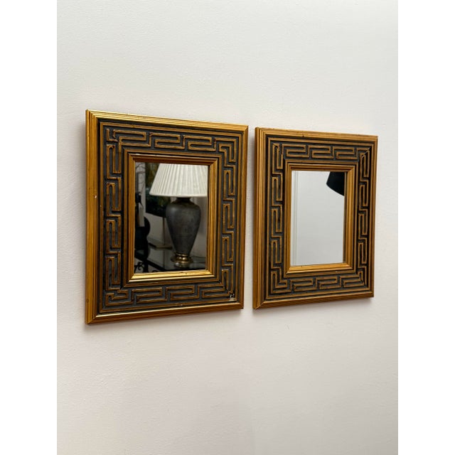 A deep three inch depth Greek key border relief comprise this pair of accent wall mirrors. The solid wood frame is in a...
