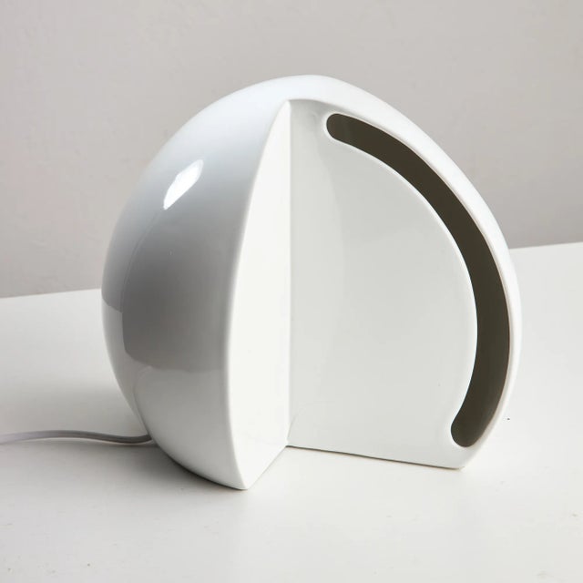 This stunning white ceramic lamp, designed in an elegant hemisphere shape, goes beyond simple utility to serve as a...
