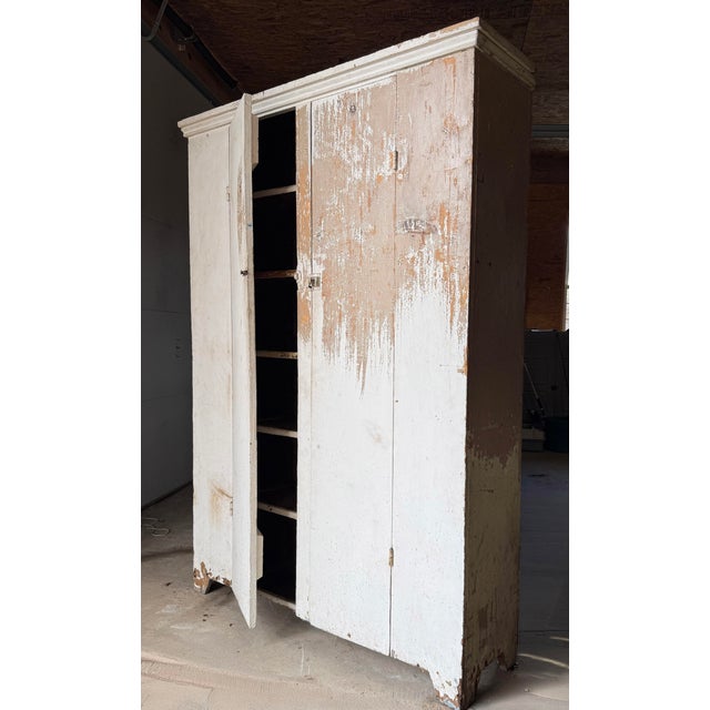 A striking 19th-century antique primitive cupboard cabinet, rich with authentic English country and farmhouse style....