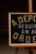 Reverse on glass (ROG) trade sign featuring gold and silver foil lettering against a black ground, reading "A DEPOSIT...