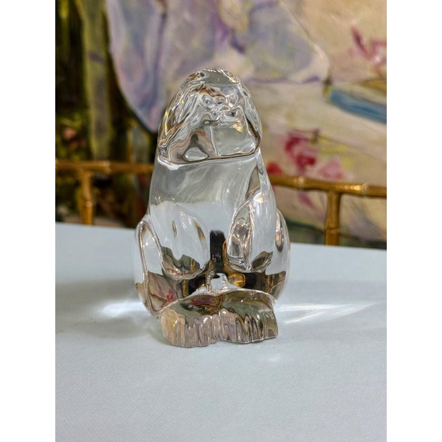 A beautifully sculpted Baccarat signed crystal rabbit, captured in a charming upright pose on its haunches with ears...