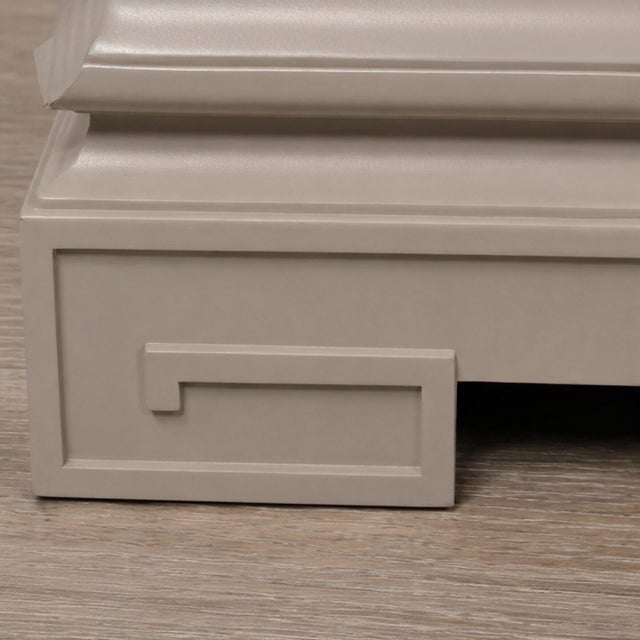 This is a pair of recently painted James Mont inspired three drawer chests or cabinets. Each chest has a large scale brass...