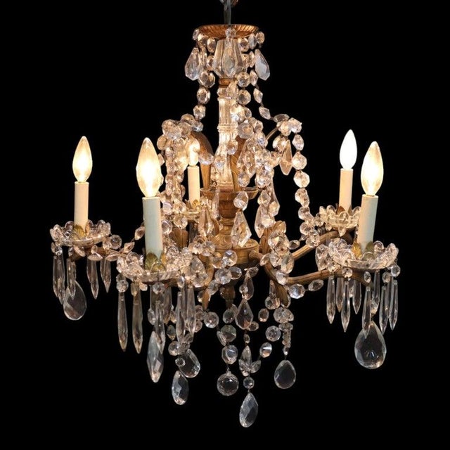This vintage French chandelier, dating to approximately 1940, is crafted in the elegant Louis XV style. It features a gilt...