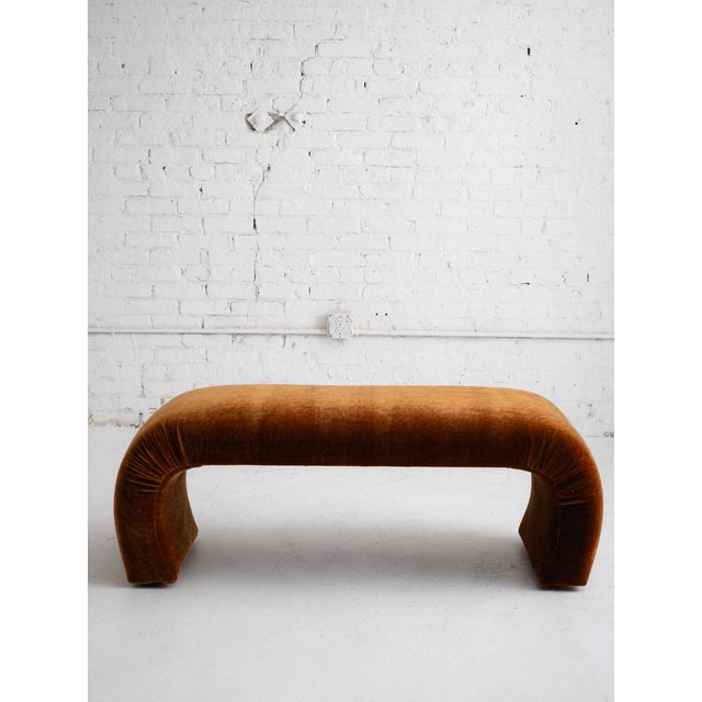 A 1980’s Post Modern waterfall bench newly reupholstered in a plush copper colored mohair. The rounded silhouette is...