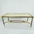 Elegant French cocktail table featuring a solid cast brass frame with a large parchment + wood tabletop. The brass is...