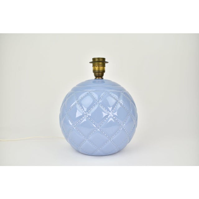 Stunning and rare ceramic table lamp. The base has a lilac / lavender colored glaze with a quilted pattern, and circles on...