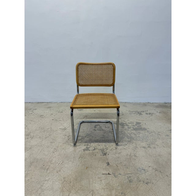 Mid-Century cantilevered Cesca chair with chrome frame and cane webbed wood seat. This chair was made sometime during the...