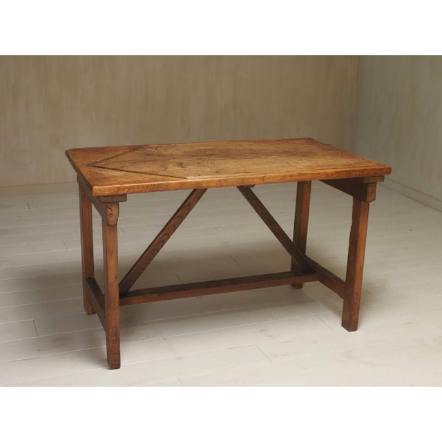 A rare antique Italian work table featuring a unique and functional design detail: two carefully carved V-shaped grooves...