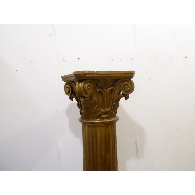 Carved wood column with bronze tone finish.