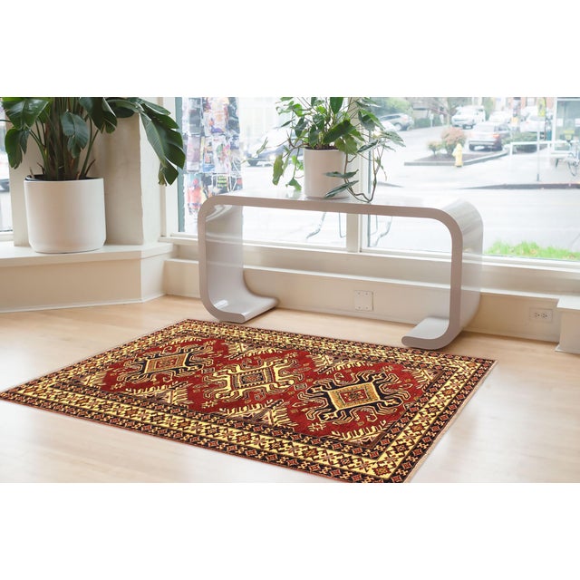 Enhance your home with this exquisite hand-knotted Super Kazak rug, crafted from fine hand-spun wool and dyed with all-...