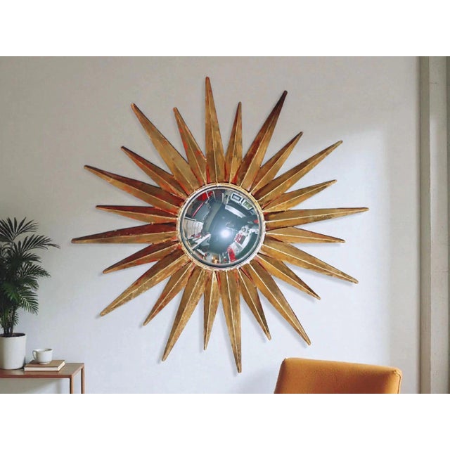 Vintage decorative mirror in the shape of a sunburst, manufactured in the late 1980s or early 1990s. Its striking design...