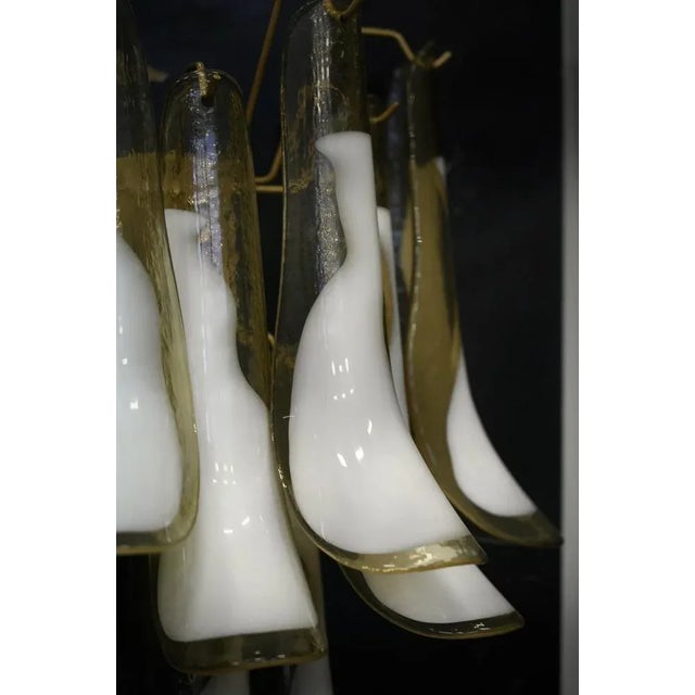 Ten beautiful leaves in classic Murano glass in amber and white. Rich design for a truly beautiful wall light. Simple and...