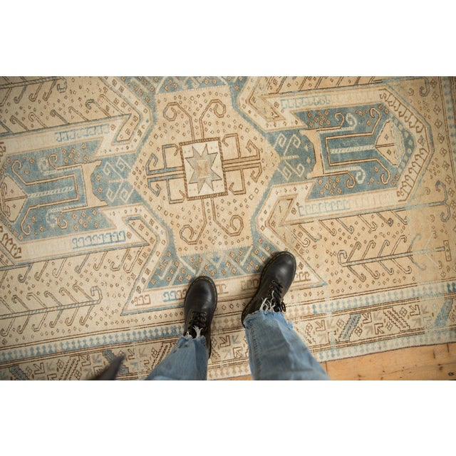 :: Oversized shield-like center medallion atop a covered field of germinating plants. Wrapped by an inner and outer minor...