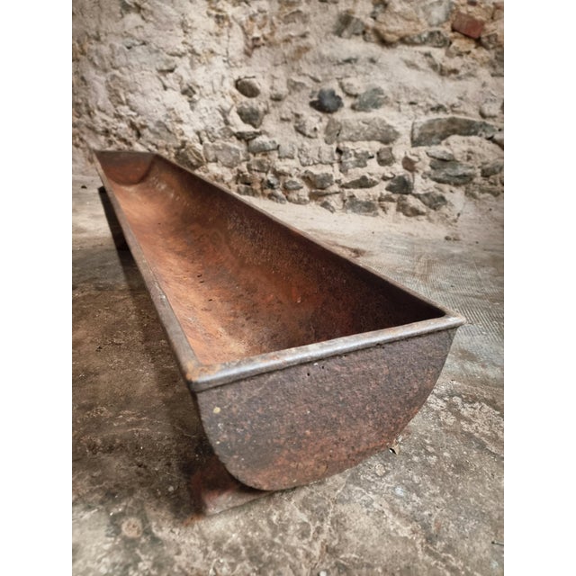 This antique French cast iron trough dates from the 19th century and originates from a rural farm setting. The piece...