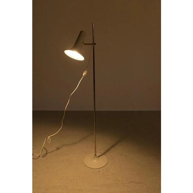 Attractive vintage floor lamp with a trumpet base and brass arm. The lamp is in good vintage condition. Measurements w. 26...