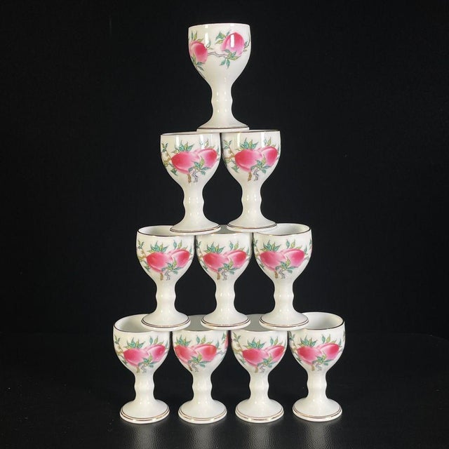 A beautiful 11-piece Chinese Famille Rose porcelain tea set. The set includes one tall, elegant teapot with a curved spout...