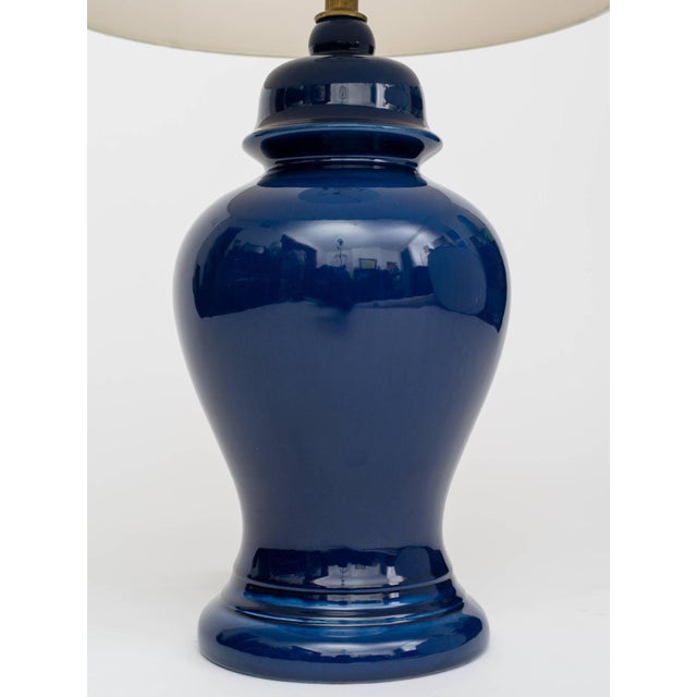 Gorgeous pair of 1960s indigo ceramic ginger jar form lamps. Lamp body measures 20" height, overall height 28.5". Shades...