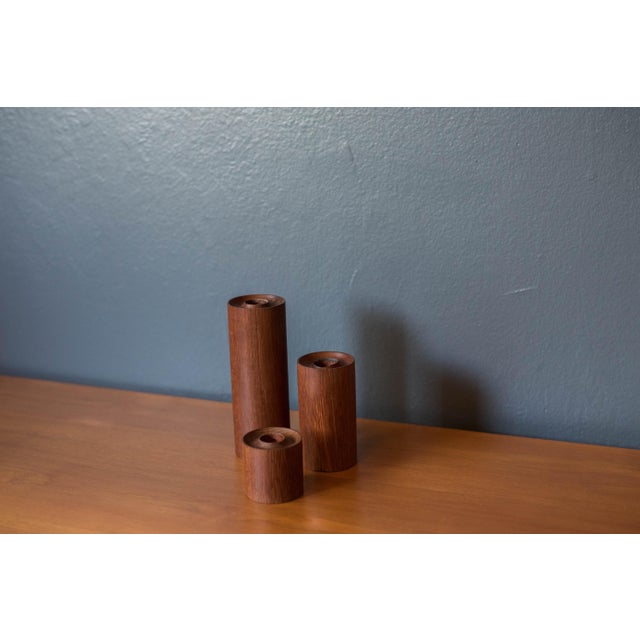 Vintage set of three cylinder candleholders in old growth teak, circa 1960's. This set comes in three different sizes and...