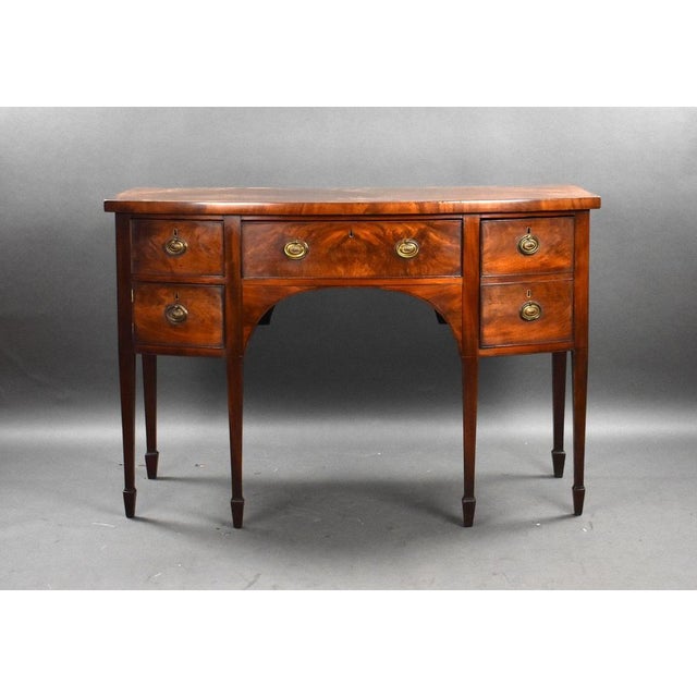 For sale is a good quality George III mahogany bow front sideboard, having an arrangement of three drawers and a single...
