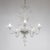 This handcrafted Cristallo Murano chandelier has five undulating scroll arms and features a bulbous center column with...