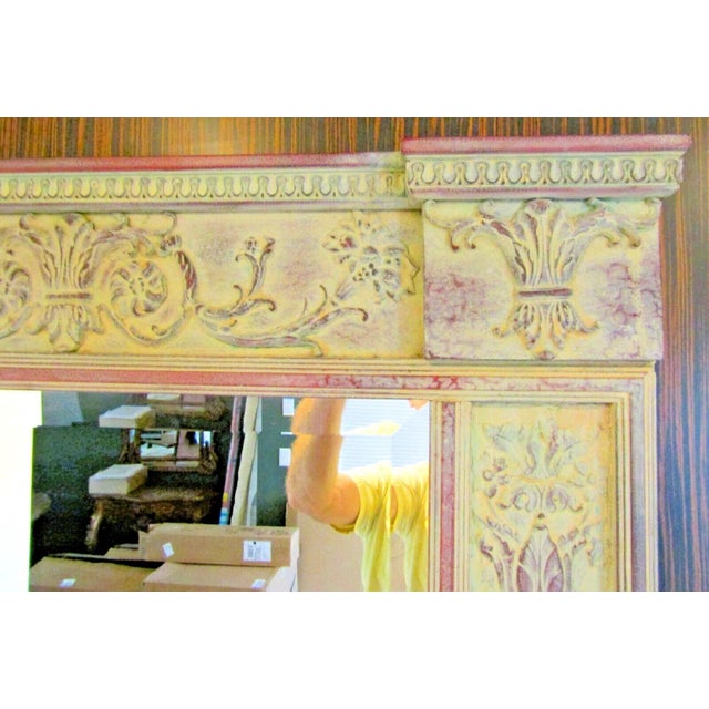 An antique French trumeau wall mirror in a pale green color with red trim. The mirror has a rectangular shape and is 53.25...