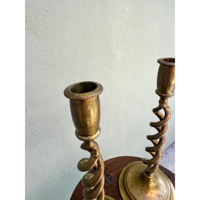 A stunning pair of antique English brass candlesticks featuring the classic barley twist design. These substantial pieces...