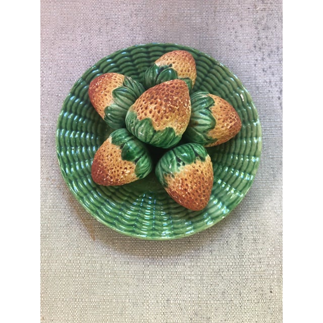 A realistic group of six strawberries on a ribbed green dish, ready to hang or place on a table. The strawberries show...