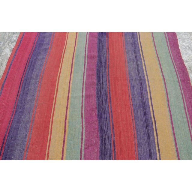 Hand-woven in wool circa 1950-1960, this 5x5 vintage Peruvian Kilim—traditionally known as a Frazada—is a radiant example...