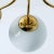 A wonderful round brass chandelier, circa 1970, made by glashütte limburg, germany. With hand-blown white glass on a brass...