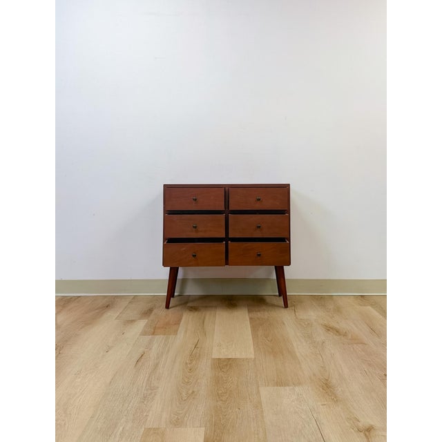This mid-century modern style chest offers a clean, streamlined silhouette suited to a range of bedroom or living space...