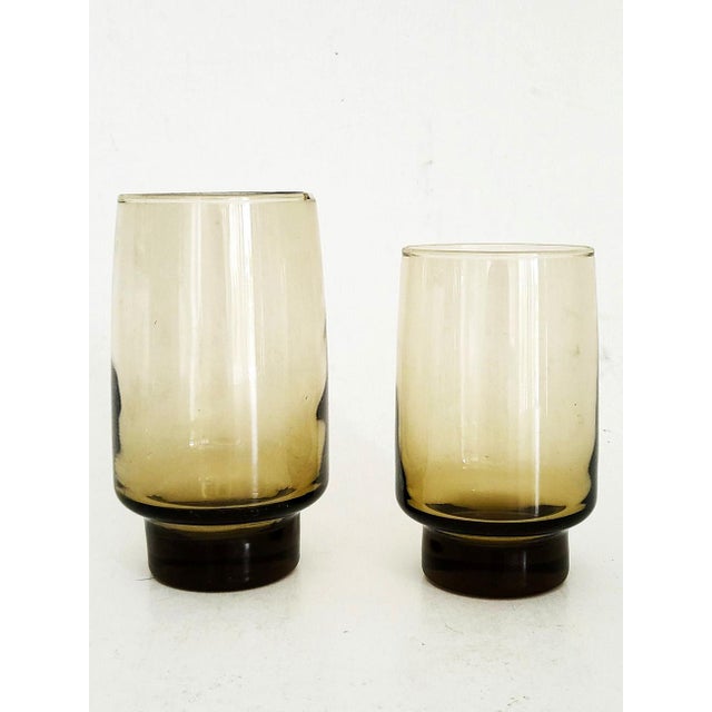 Offered is a set of 8 highball tumblers from Libbey Glass in their iconic mid 20th century Tawny Accent color, a sunken...
