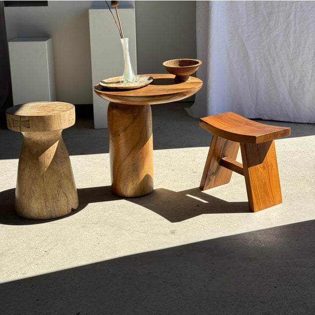 Side table in solid suar wood with a circular top and column base. Elegant and timeless geometric shape. The piece is...