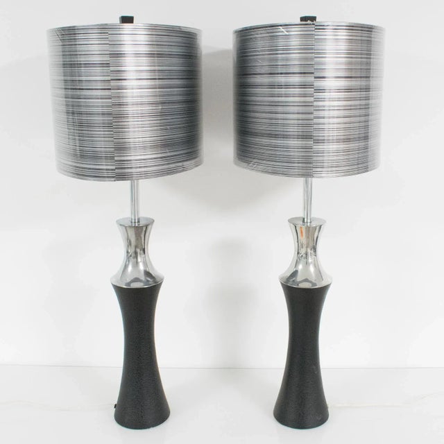 This pair of table lamps, designed by Mutual Sunset Lamp Co., Brooklyn, NY, features a modernist Machine Age shape with...