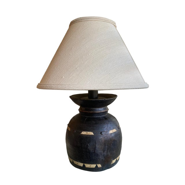 A vintage rustic lamp that was custom made from an antique wood milk pot from India, c. 1990s. Pot shows great patina from...