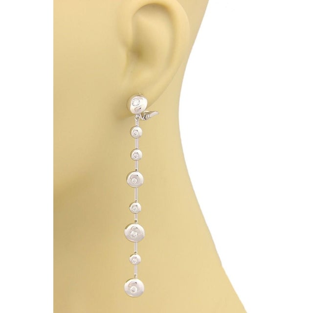 The Koesia Diamond 18k White Gold Fancy Spinner Discs Long Earrings are a stunning piece of vintage and antique jewelry....
