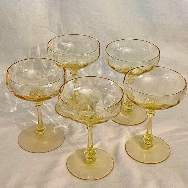 Heisey Dominion champagne/tall sherbet glass features a delicate canary yellow hue and a detailed, ornate stem....