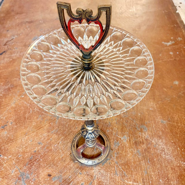 A charming and highly decorative vintage pedestal accent table featuring a sparkling pressed glass top supported by an...
