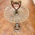 A charming and highly decorative vintage pedestal accent table featuring a sparkling pressed glass top supported by an...