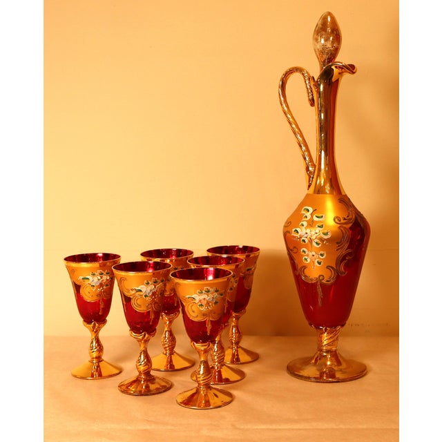 This complete set, comprising a beautiful decanter and six matching stemmed glasses, was created in the early 1960s by...