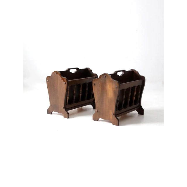 A handsome pair of mid-century magazine racks by Leick Furniture, crafted in a warm lodge-style wood with a distinctly...