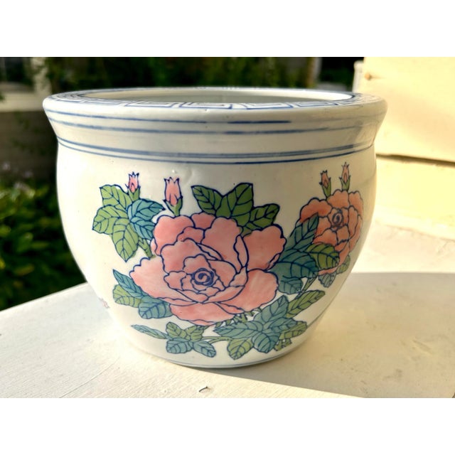 Vintage Chinese fishbowl planter. Adorned with pink roses and green leaves. Blue and white Greek key pattern along the top...