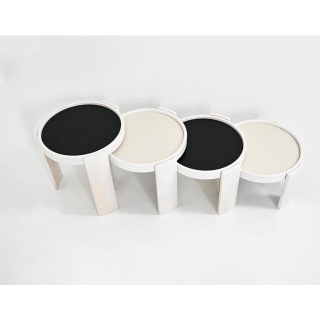 Wooden nesting table. Reversible black and white top. Stamped Cassina. Wear due to time and age of the table. Measures:...