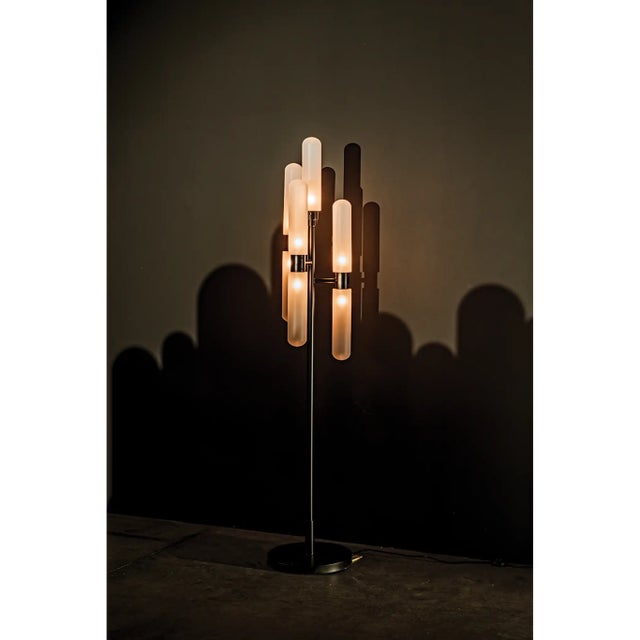 A modern, candelabra-style floor lamp, the Dominique features 3 arms with top and bottom frosted capsule glass shades and...