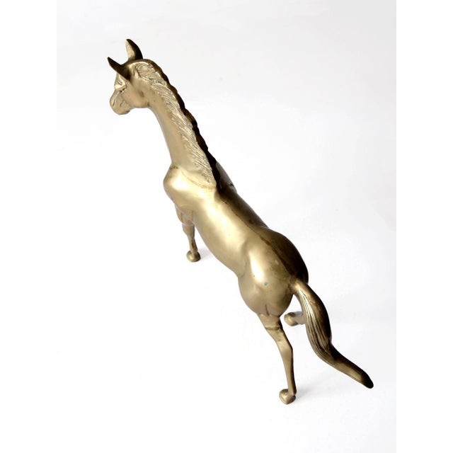 This mid-20th century brass horse statue features a polished finish and elegant details. Its graceful pose adds timeless...