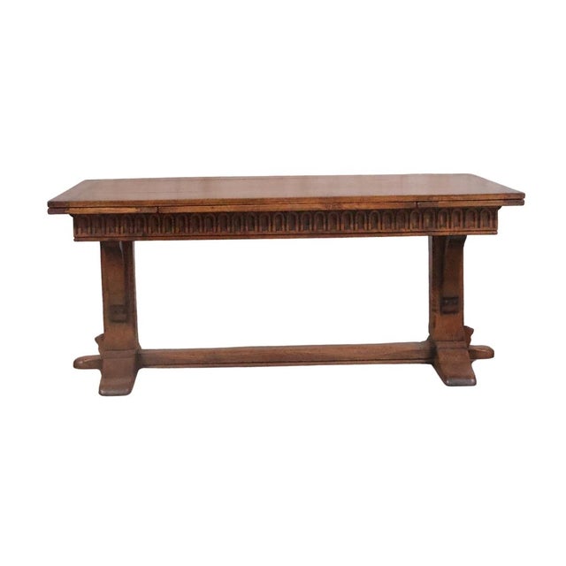 This 19th Century English Oak Extension Drawing Table is a rare and character-rich antique that highlights the durability...