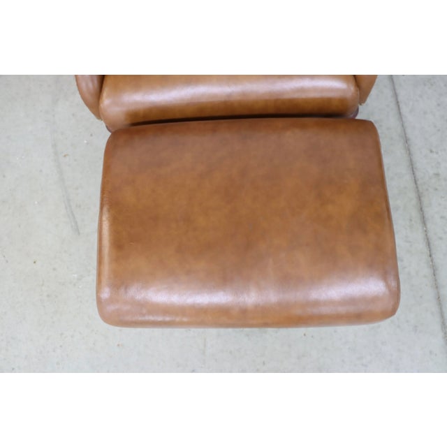 Stickley leather wingback chair and ottoman with brass nailhead trim and mahogany legs. ottoman 19d x 25w x 17h