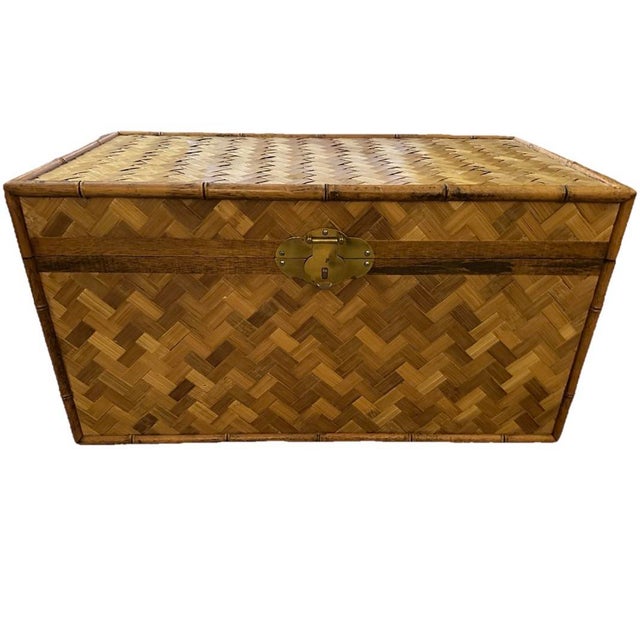 Vintage 20th Century Asian style woven rattan and faux bamboo storage trunk. It has a distinct herringbone pattern with...