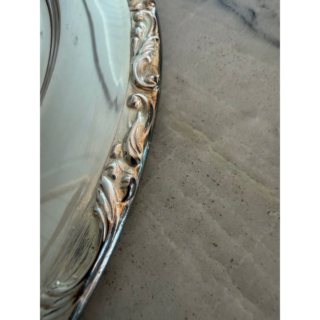 This elegant scroll-edged silver plate charger will elevate your dinner tablescape. 11 3/4" diameter. 15 available